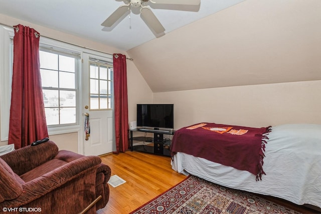 bedroom with lofted ceiling, wood-type flooring, and ceiling fan