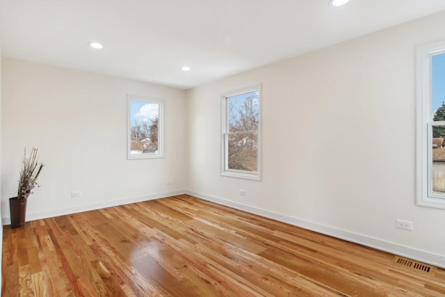 unfurnished room with light hardwood / wood-style floors