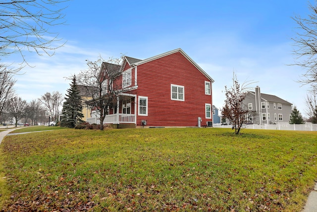 view of home's exterior featuring a porch and a lawn