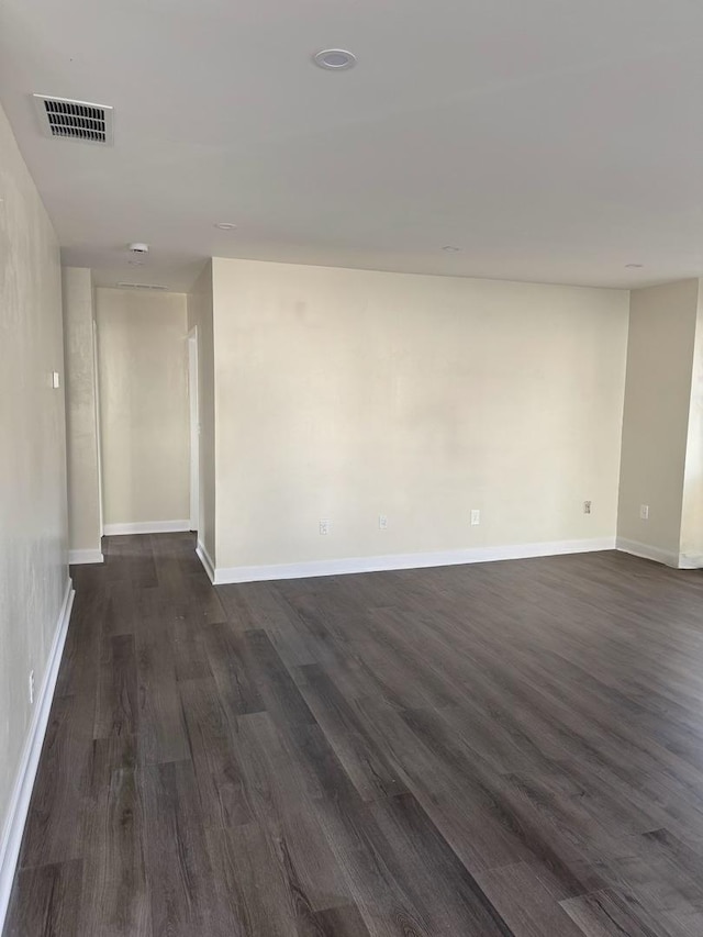 unfurnished room featuring dark wood-type flooring