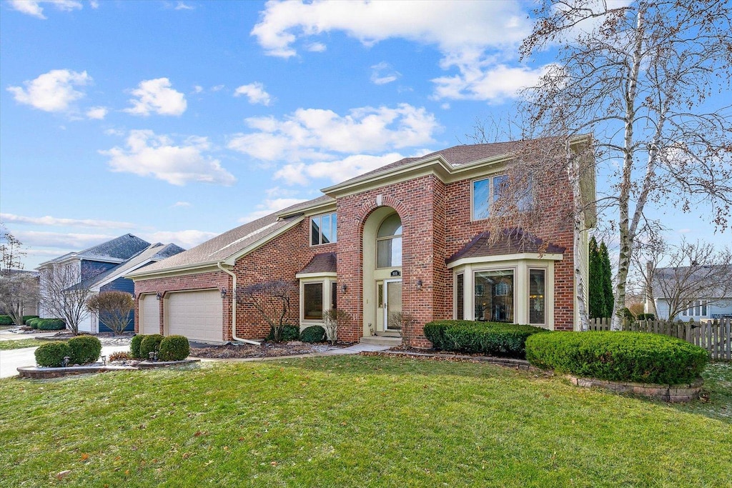 view of front of property with a front yard and a garage