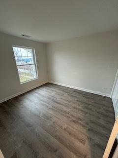 spare room featuring dark hardwood / wood-style flooring