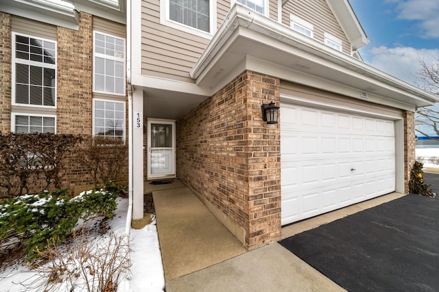 doorway to property with a garage