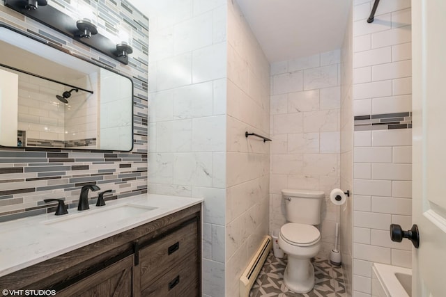 full bathroom with tasteful backsplash, a baseboard heating unit, toilet, vanity, and tile walls