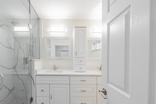 bathroom featuring vanity and an enclosed shower