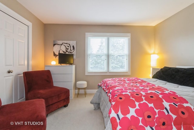 bedroom featuring light carpet