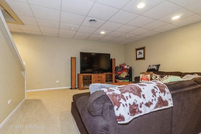 carpeted living room featuring a paneled ceiling