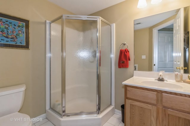 bathroom with tile patterned flooring, vanity, toilet, and a shower with shower door