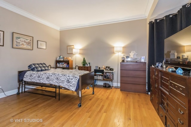 bedroom featuring crown molding and light hardwood / wood-style floors