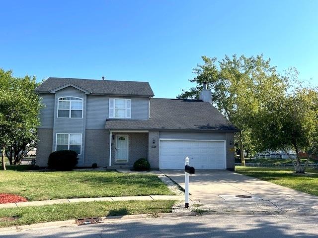 view of front property with a garage and a front lawn