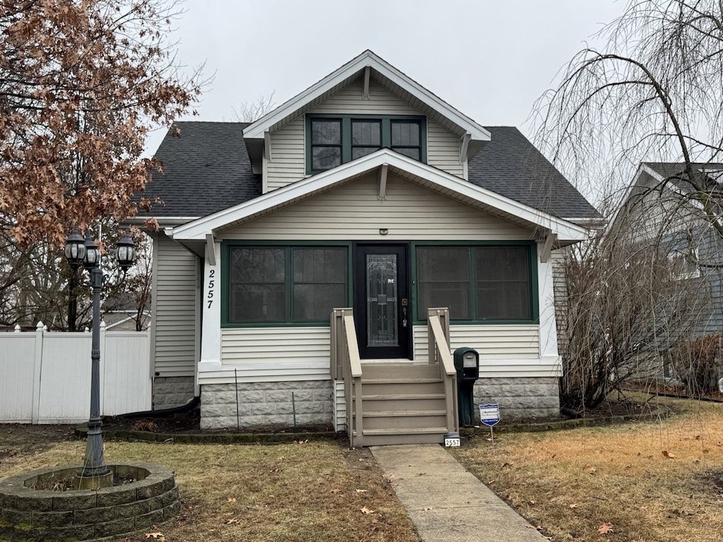 bungalow-style home with a front lawn