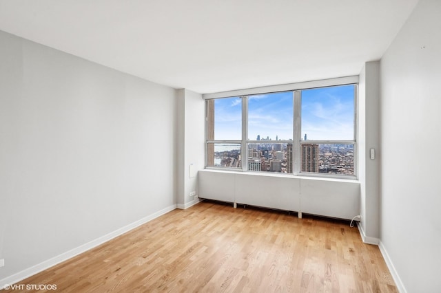 empty room with light hardwood / wood-style floors