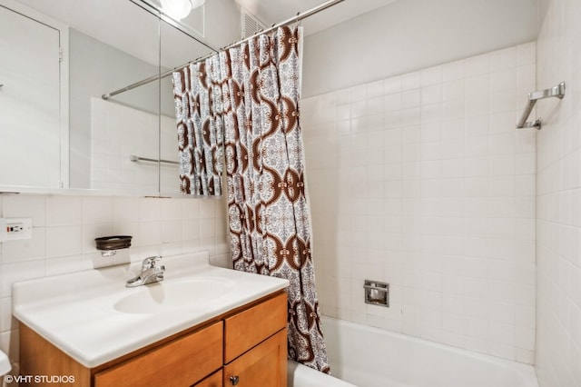 bathroom with shower / bathtub combination with curtain, decorative backsplash, and vanity