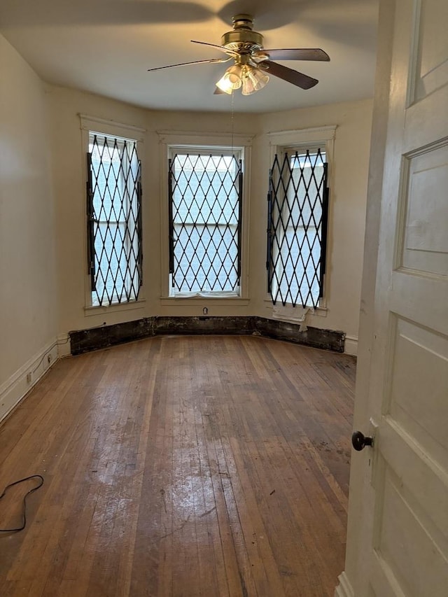 empty room featuring wood-type flooring and ceiling fan