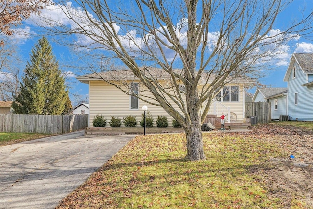 exterior space featuring central AC unit and a front yard