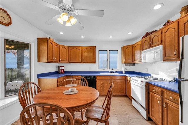 kitchen with ceiling fan, sink, a healthy amount of sunlight, and white appliances