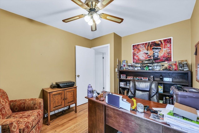 home office featuring light wood-type flooring and ceiling fan