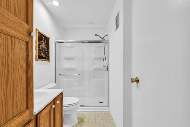 bathroom with vanity, an enclosed shower, and toilet