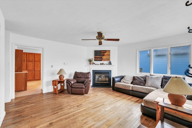 living room featuring ceiling fan and light wood-type flooring