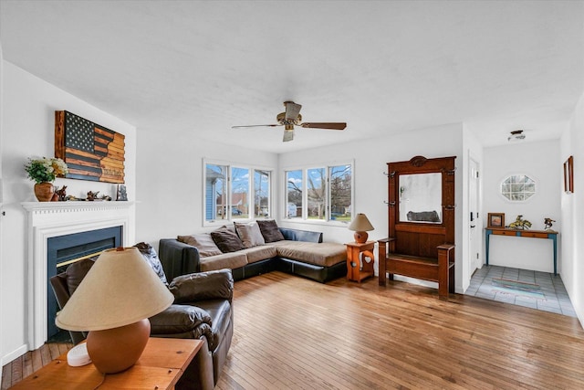 living room featuring ceiling fan and hardwood / wood-style floors