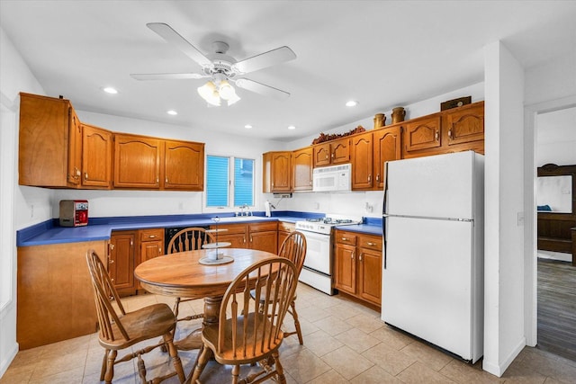 kitchen with ceiling fan, light tile patterned floors, and white appliances