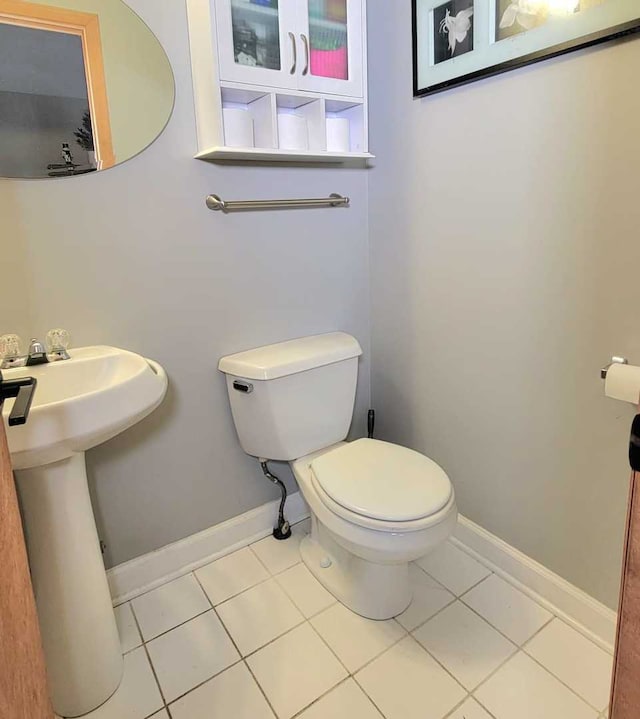 bathroom featuring sink, tile patterned flooring, and toilet