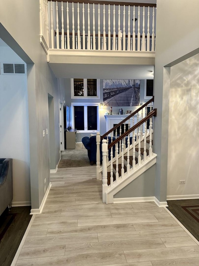 staircase featuring a high ceiling