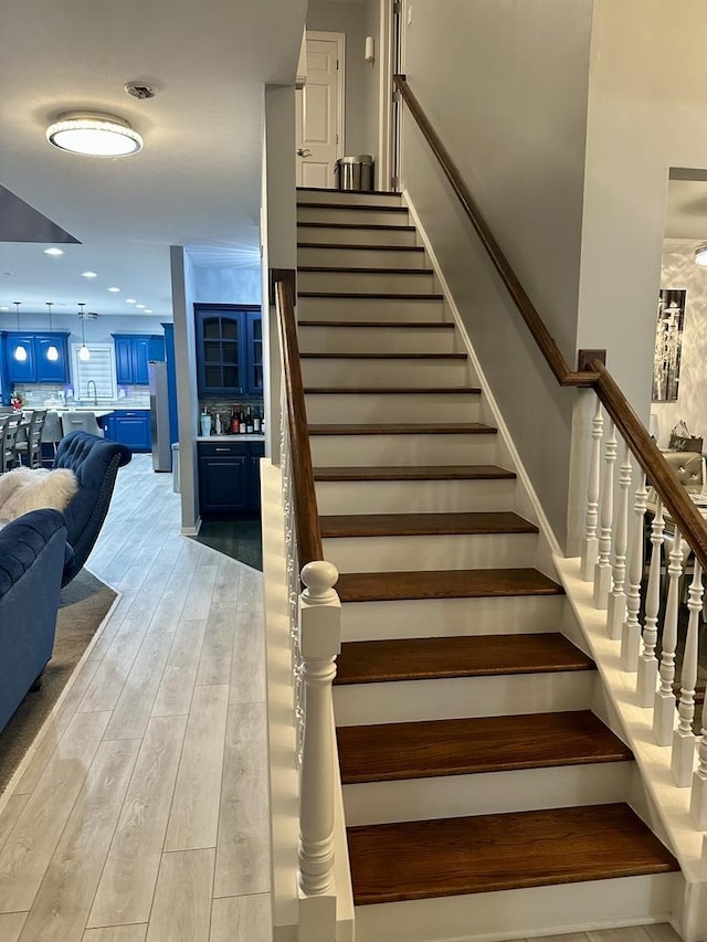 stairs featuring wood-type flooring