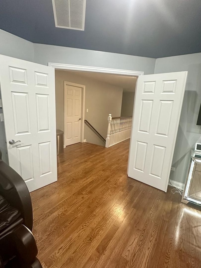 additional living space featuring dark hardwood / wood-style flooring