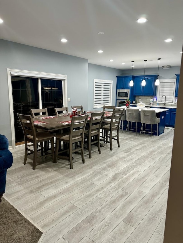 dining room featuring light hardwood / wood-style flooring and sink