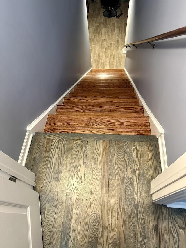 stairs with hardwood / wood-style floors