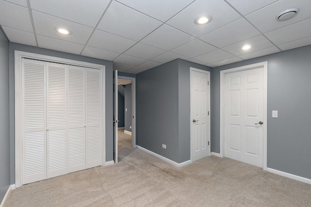 unfurnished bedroom featuring a closet and light colored carpet