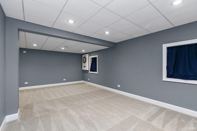 basement featuring light colored carpet