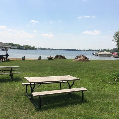 view of property's community with a yard and a water view