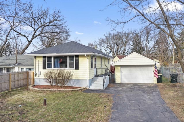 view of front facade with an outbuilding, a front lawn, and a garage