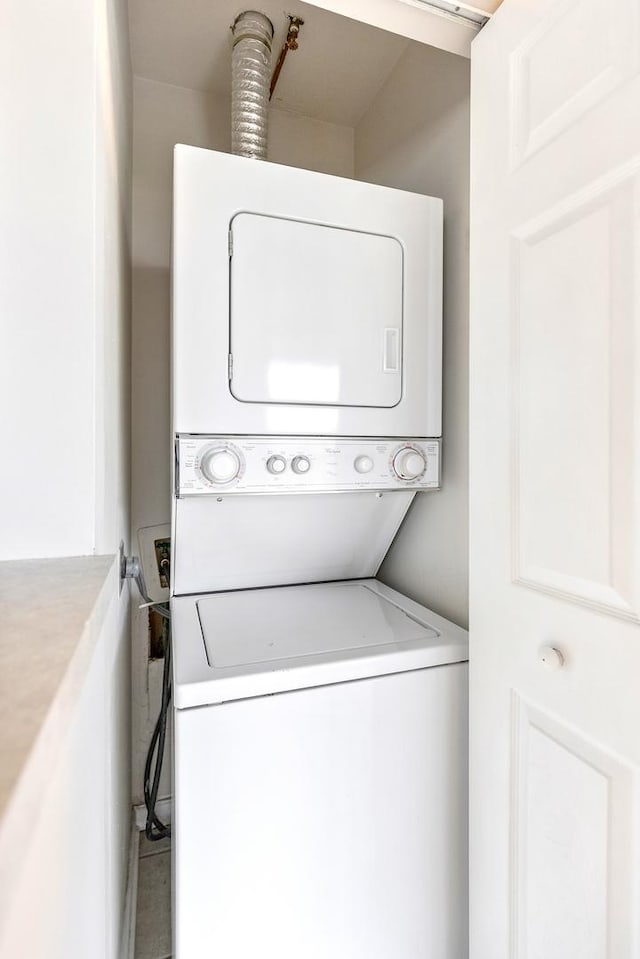 laundry area with stacked washer and clothes dryer