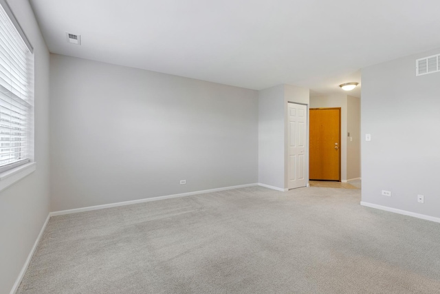 unfurnished room featuring light colored carpet