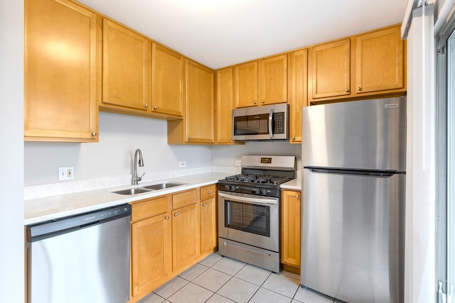 kitchen featuring sink, light tile patterned floors, and stainless steel appliances