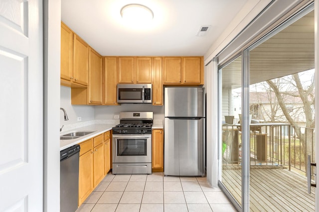 kitchen featuring sink, light tile patterned floors, and stainless steel appliances