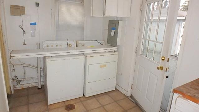 laundry room featuring washer and dryer and light tile patterned floors