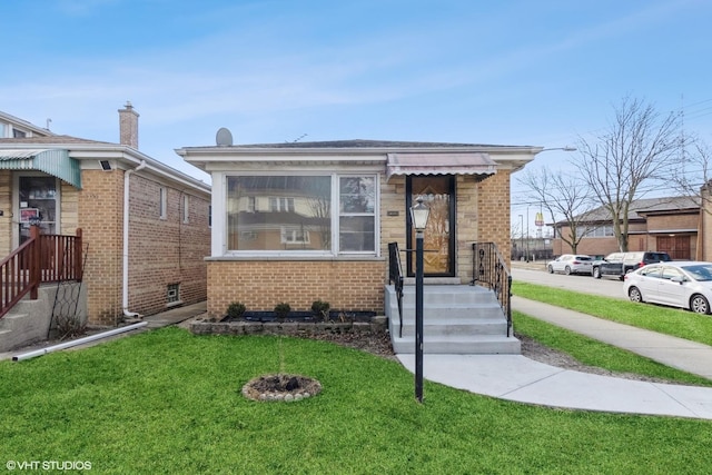 bungalow-style home featuring a front yard and brick siding