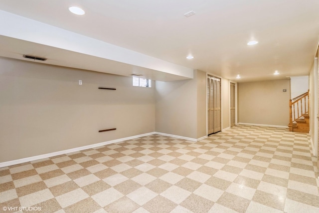 below grade area featuring stairs, baseboards, visible vents, and recessed lighting