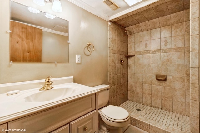 full bathroom with toilet, visible vents, vanity, a tile shower, and crown molding