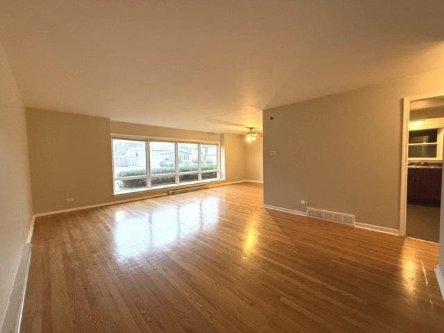 spare room featuring ceiling fan and wood-type flooring