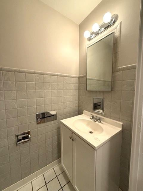 bathroom with vanity, tile patterned floors, and tile walls