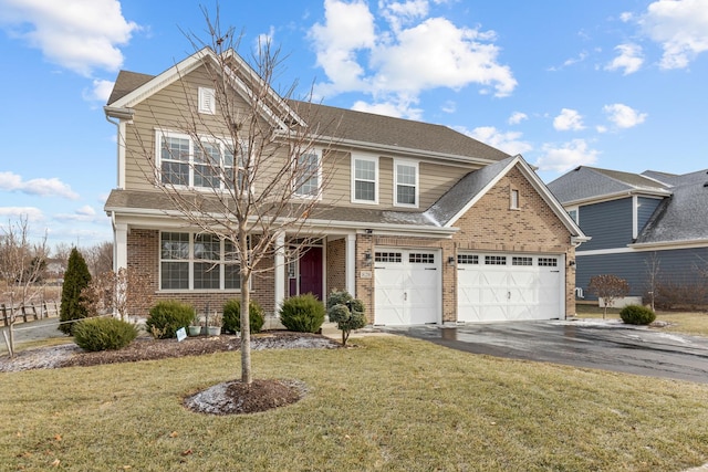 view of front of house featuring a front lawn and a garage