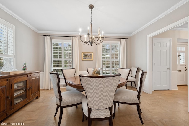 dining space featuring light parquet flooring, an inviting chandelier, and crown molding