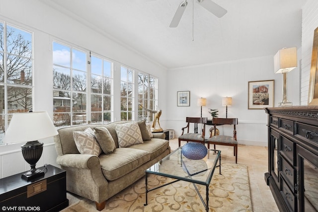 tiled living room featuring ornamental molding and ceiling fan