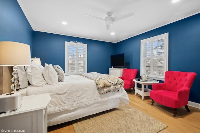 bedroom featuring crown molding, ceiling fan, and light wood-type flooring