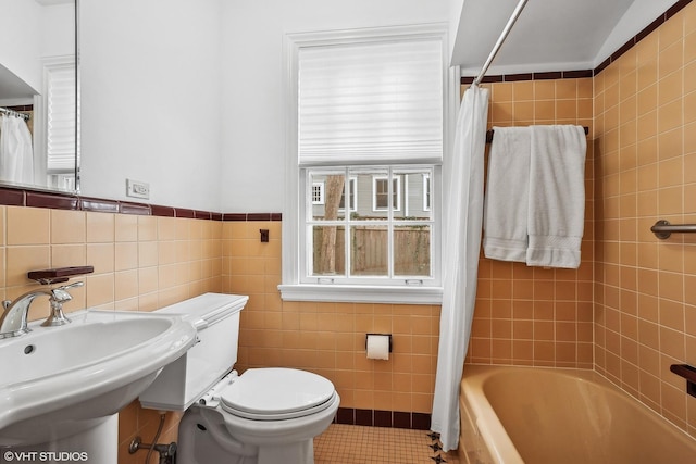 full bathroom featuring sink, tile walls, tile patterned flooring, shower / tub combo, and toilet